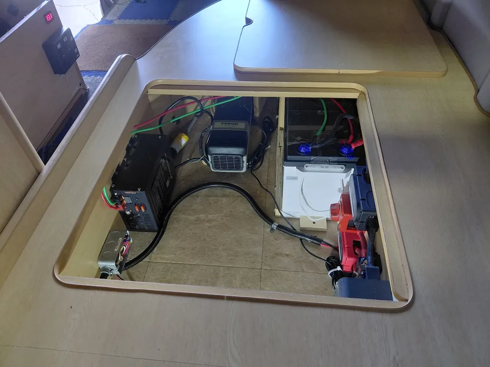 Under-floor RV compartment power system upgrade with inverter/charger, Webasto heater, battery bank, and fuse panel wired together