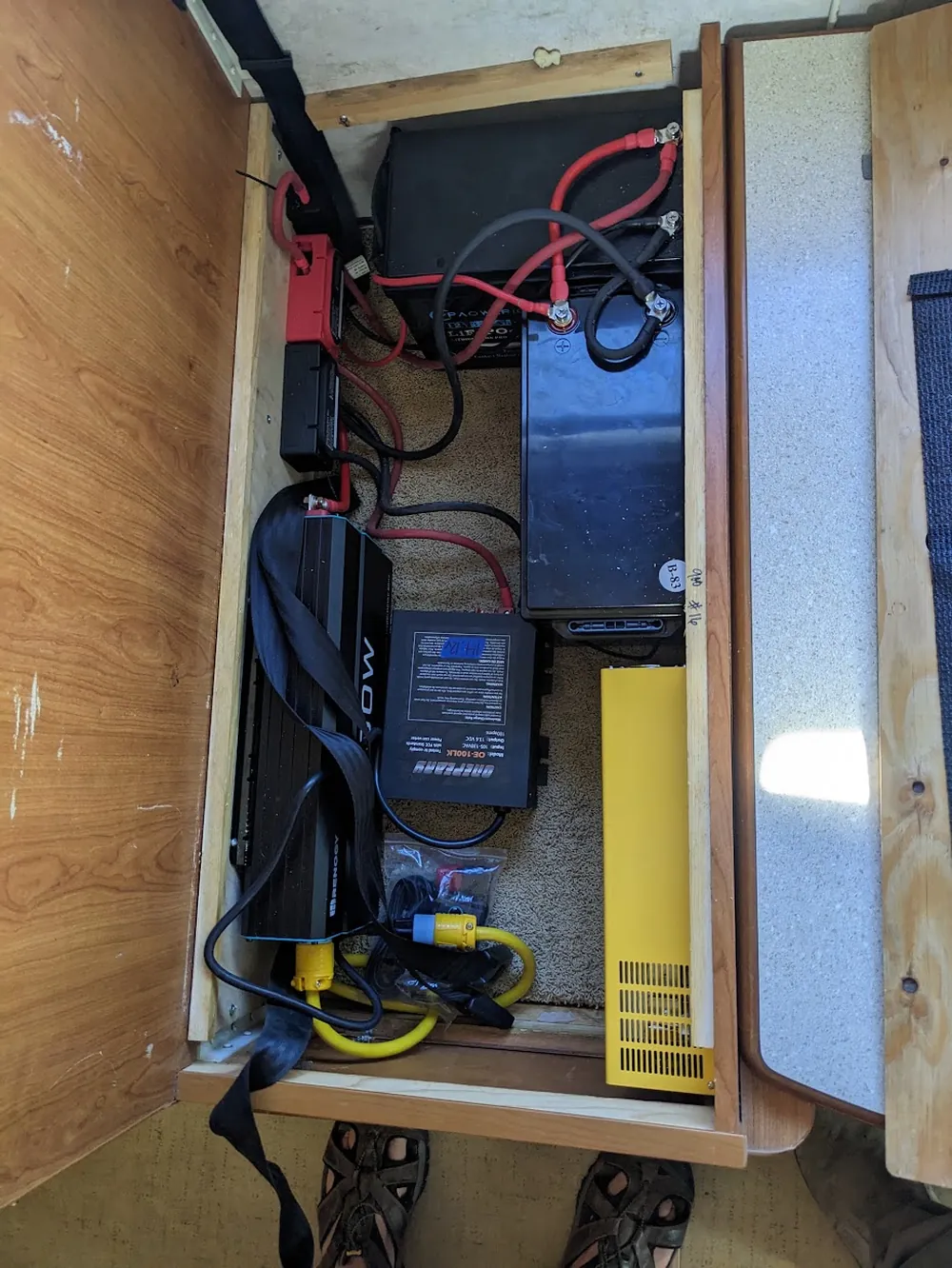RV under-seat battery compartment with lithium batteries, inverter, DC-DC charger, and AC transfer boxes wired together